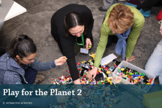 Play for the Planet 2, image shows people sat on floor playing with a big pile of lego